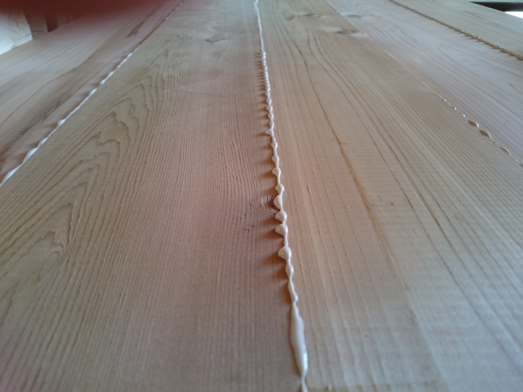 The excess glue squeezing out evenly from the boards.