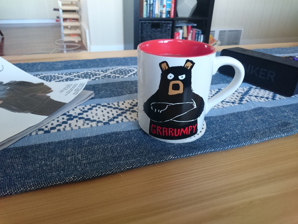 First cup of coffee on the coffee table. The mug does not at all describe my current mood!